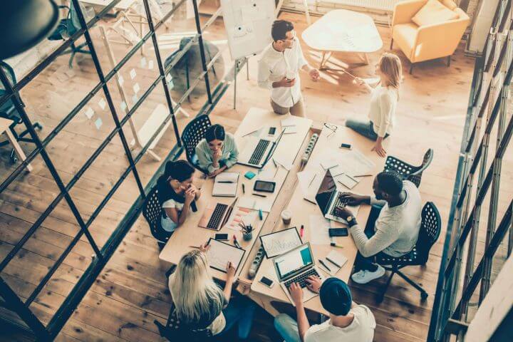 Team having a catch up in a meeting room, inside a modern office