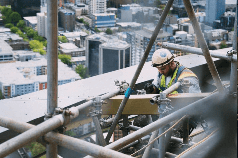 Worker in field fixing cables
