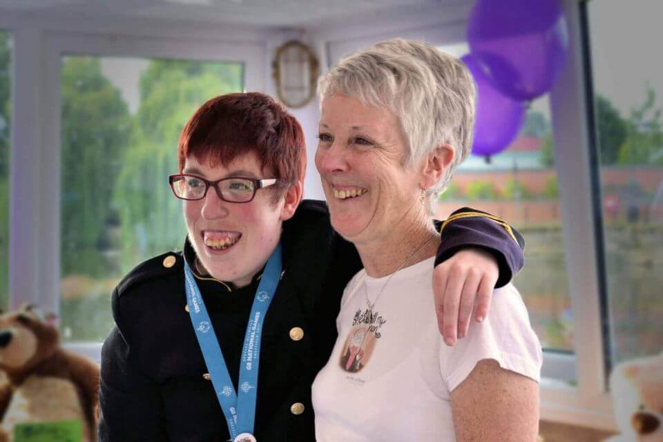 Mum and son smiling whilst at a party