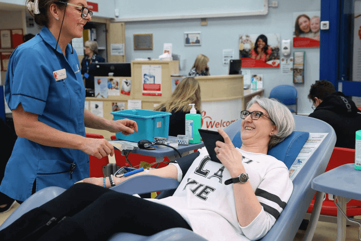 Woman laying on bed about to give blood