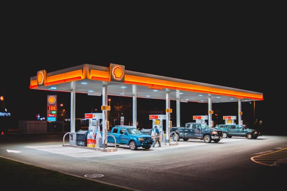 Multiple cars at petrol station at night