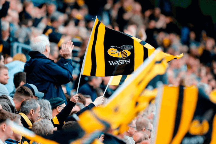 Wasps rugby supporters flying flags in the stands