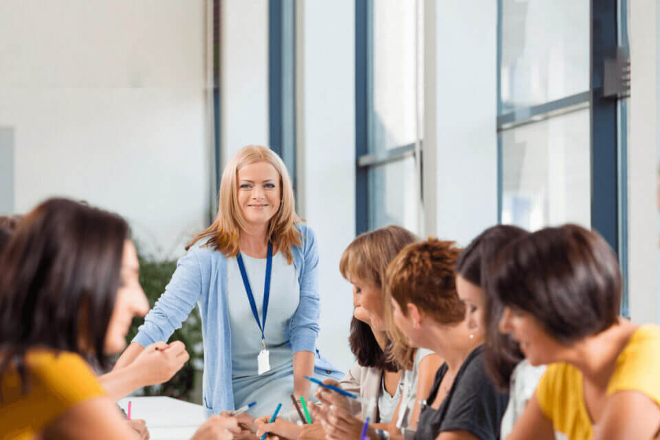 Training seminar showing multiple people and one lecturer