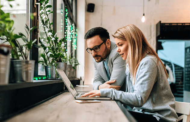 Two people working together on a laptop